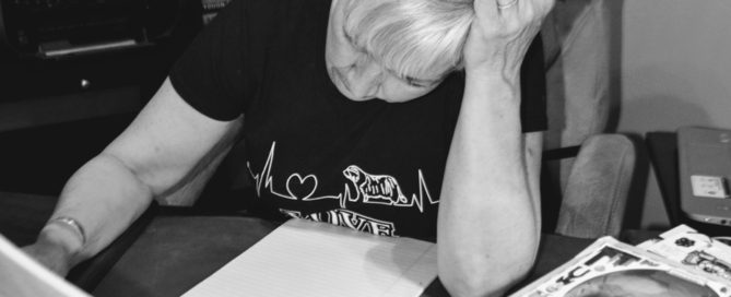 Woman Looks at Notepad